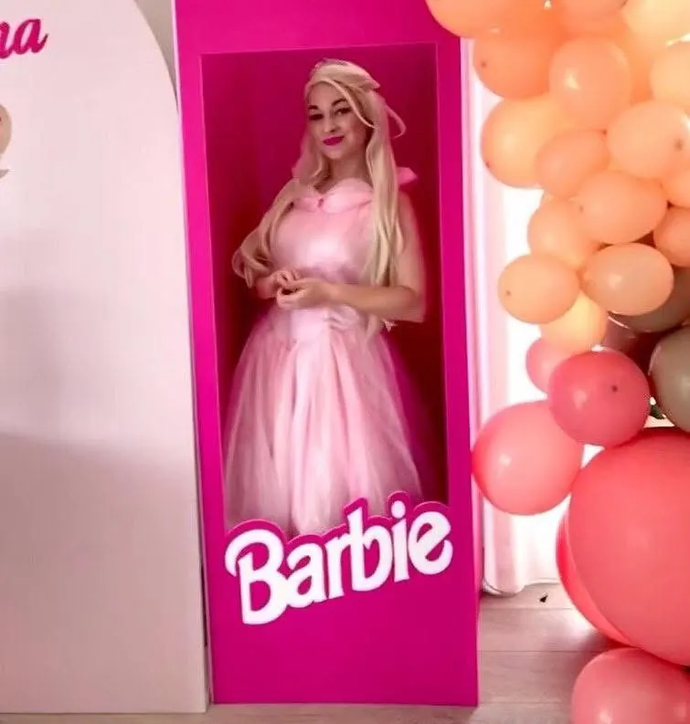 Barbie entertainer posing inside a life-size Barbie box display at a pink-themed Melbourne birthday party