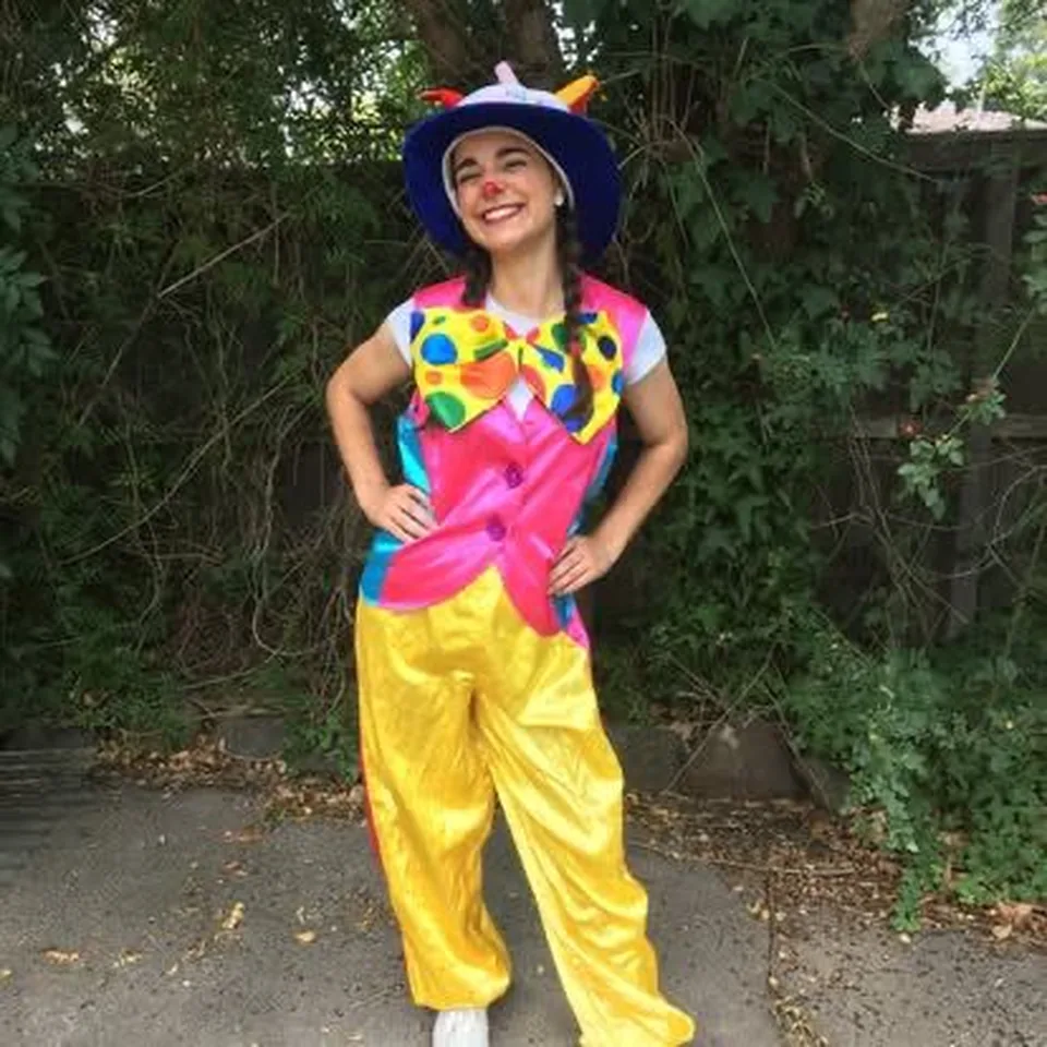 Bubbles the Clown party entertainer in rainbow polka dot vest and yellow pants posing outdoors for a Melbourne circus themed kids birthday party